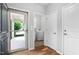 Light-filled entryway features hardwood floors, glass door, laundry room, and a coat closet at 1019 Santiago St, Durham, NC 27703