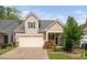 Charming two-story home with a two car garage, quaint landscaping, and covered porch at 1019 Santiago St, Durham, NC 27703
