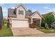 Charming two-story home with a two car garage, quaint landscaping, and a porte-cochere at 1019 Santiago St, Durham, NC 27703
