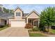Charming two-story home with a two car garage, quaint landscaping, and covered porch at 1019 Santiago St, Durham, NC 27703