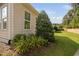Manicured landscaping with colorful flowers and green shrubs around the beige siding of the house at 1019 Santiago St, Durham, NC 27703
