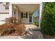 Charming front entrance featuring a covered porch with columns, lush landscaping, and a welcoming front door at 1019 Santiago St, Durham, NC 27703