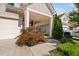 Inviting front entrance featuring a covered porch, manicured landscaping, and a charming Japanese maple at 1019 Santiago St, Durham, NC 27703