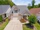 Charming two-story home featuring a well-manicured lawn and a two-car garage in a desirable community at 1019 Santiago St, Durham, NC 27703