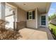 Welcoming front porch showcasing a covered entry, brick accents, and convenient access to the garage at 1019 Santiago St, Durham, NC 27703