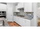 Well-equipped kitchen featuring white cabinets, granite countertops, stainless steel appliances, and a gas range at 1019 Santiago St, Durham, NC 27703