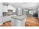 Modern kitchen with granite countertops, stainless steel appliances and a large island open to living room at 1019 Santiago St, Durham, NC 27703
