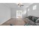 Comfortable living room with a ceiling fan, plush carpeting, and glass-paneled door at 1019 Santiago St, Durham, NC 27703