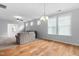 Spacious living room with hardwood floors, large windows, and a ceiling fan at 1019 Santiago St, Durham, NC 27703