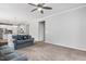 Open living room featuring a ceiling fan and access to the kitchen at 1019 Santiago St, Durham, NC 27703