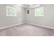Spacious basement with carpeting and natural light from two windows overlooking the yard at 102 Emerald Cir, Durham, NC 27713