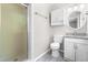 Bathroom with glass shower, toilet, vanity with granite countertop, and a round mirror at 102 Emerald Cir, Durham, NC 27713