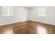 Bright bedroom with hardwood floors and windows offering great light, ready for personalization at 102 Emerald Cir, Durham, NC 27713
