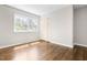 Bright bedroom with hardwood floors and a closet, complemented by natural light through a window at 102 Emerald Cir, Durham, NC 27713