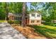 Beautiful home with a freshly mowed yard, brick facade, siding, and a red front door at 102 Emerald Cir, Durham, NC 27713