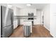 Updated kitchen with stainless steel appliances, granite countertops, and a center island at 102 Emerald Cir, Durham, NC 27713