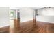 View of open-concept living room with hardwood floors leading to the kitchen and backyard at 102 Emerald Cir, Durham, NC 27713