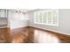 Spacious living room featuring beautiful hardwood floors and a large bay window at 102 Emerald Cir, Durham, NC 27713