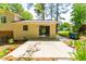 Concrete patio featuring a glass sliding door, trash cans, potted plants, and tree shade at 102 Emerald Cir, Durham, NC 27713