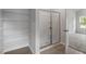 Bathroom featuring walk-in shower, wire shelving, vinyl flooring, and neutral walls at 102 Flue Ct, Oxford, NC 27565
