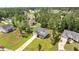 An aerial view of a gray house with a well-maintained lawn and surrounded by mature trees in a quiet neighborhood at 103 Foothill Ct, Sanford, NC 27330