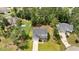Gray two-story house with a well-manicured lawn, driveway, and surrounded by mature trees at 103 Foothill Ct, Sanford, NC 27330