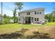 Large backyard with a covered porch, a well-maintained lawn, and mature trees at 103 Foothill Ct, Sanford, NC 27330