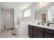 Bathroom featuring double sinks, soaking tub and shower, offering a spa-like retreat at 103 Foothill Ct, Sanford, NC 27330
