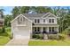 Charming two-story home with a well-manicured lawn, inviting front porch, and attached two-car garage at 103 Foothill Ct, Sanford, NC 27330