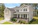 Charming two-story home with a front porch, manicured landscaping, and inviting curb appeal at 103 Foothill Ct, Sanford, NC 27330
