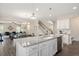 Open-concept kitchen with granite island, stainless sink, and views of the living and dining areas at 103 Foothill Ct, Sanford, NC 27330