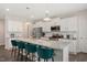 Bright kitchen features white cabinets, granite counters, stainless appliances, and teal bar stools at 103 Foothill Ct, Sanford, NC 27330
