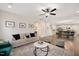 Comfortable living room featuring a neutral color palette, fireplace, and open access to kitchen and dining area at 103 Foothill Ct, Sanford, NC 27330