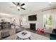 Open-concept living area with seamless flow to kitchen, fireplace, and hardwood flooring throughout at 103 Foothill Ct, Sanford, NC 27330