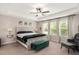 Tranquil main bedroom with tray ceiling, bench, and large windows with natural light at 103 Foothill Ct, Sanford, NC 27330