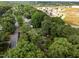 An aerial view shows homes and businesses nestled among the tree lined streets in the neighborhood at 1040 Ivy Ln, Cary, NC 27511
