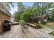 Wooden patio area with a grill and a lush green backdrop creating a relaxing outdoor space at 1040 Ivy Ln, Cary, NC 27511