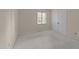Neutral carpeted bedroom with double closet and window creating a bright atmosphere at 1040 Ivy Ln, Cary, NC 27511