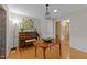 Dining area with hardwood floors, piano, and decorative artwork at 1040 Ivy Ln, Cary, NC 27511