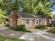 Side view of a well maintained single Gathering home with brick chimney and mature trees at 1040 Ivy Ln, Cary, NC 27511