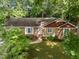This charming brick home has neutral colored siding, a walkway to the front door and well manicured landscaping at 1040 Ivy Ln, Cary, NC 27511
