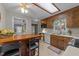 Eat-in kitchen featuring wooden cabinets, and skylight at 1040 Ivy Ln, Cary, NC 27511