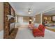 View of a second living area with fireplace, ceiling fan, plush carpet and warm tones at 1040 Ivy Ln, Cary, NC 27511