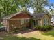 The rear exterior of this brick home features a fenced backyard, brick and siding, and a sliding glass door at 1040 Ivy Ln, Cary, NC 27511