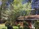 Lush landscaping with blooming trees complements this charming building at 1040 Ivy Ln, Cary, NC 27511