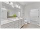 Bright bathroom features double sink vanity, large mirror, and neutral tile at 10511 Sablewood Dr # 107, Raleigh, NC 27617
