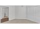 Bright bedroom features neutral carpet, double door closet, and doorway to laundry room at 10511 Sablewood Dr # 107, Raleigh, NC 27617
