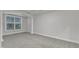 Spacious bedroom with large window for natural light and neutral color palette at 10511 Sablewood Dr # 107, Raleigh, NC 27617
