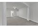 Large carpeted room featuring classic white columns and arched entryway at 10511 Sablewood Dr # 107, Raleigh, NC 27617