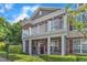 Charming brick townhouse with a covered front porch, a second-story balcony, and neatly trimmed landscaping at 10511 Sablewood Dr # 107, Raleigh, NC 27617